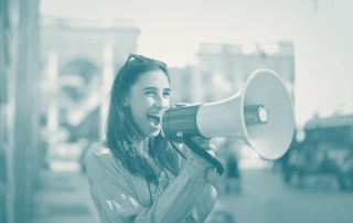 Young woman with a bullhorn, symbolising the power of content marketing for startups in amplifying brand storytelling and reaching potential customers.