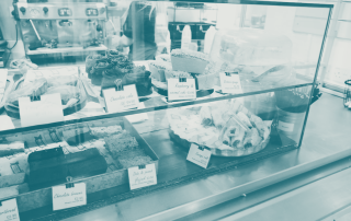 Customer buying cakes at a small bakery, symbolising investment returns, TROI for startups and SMEs.